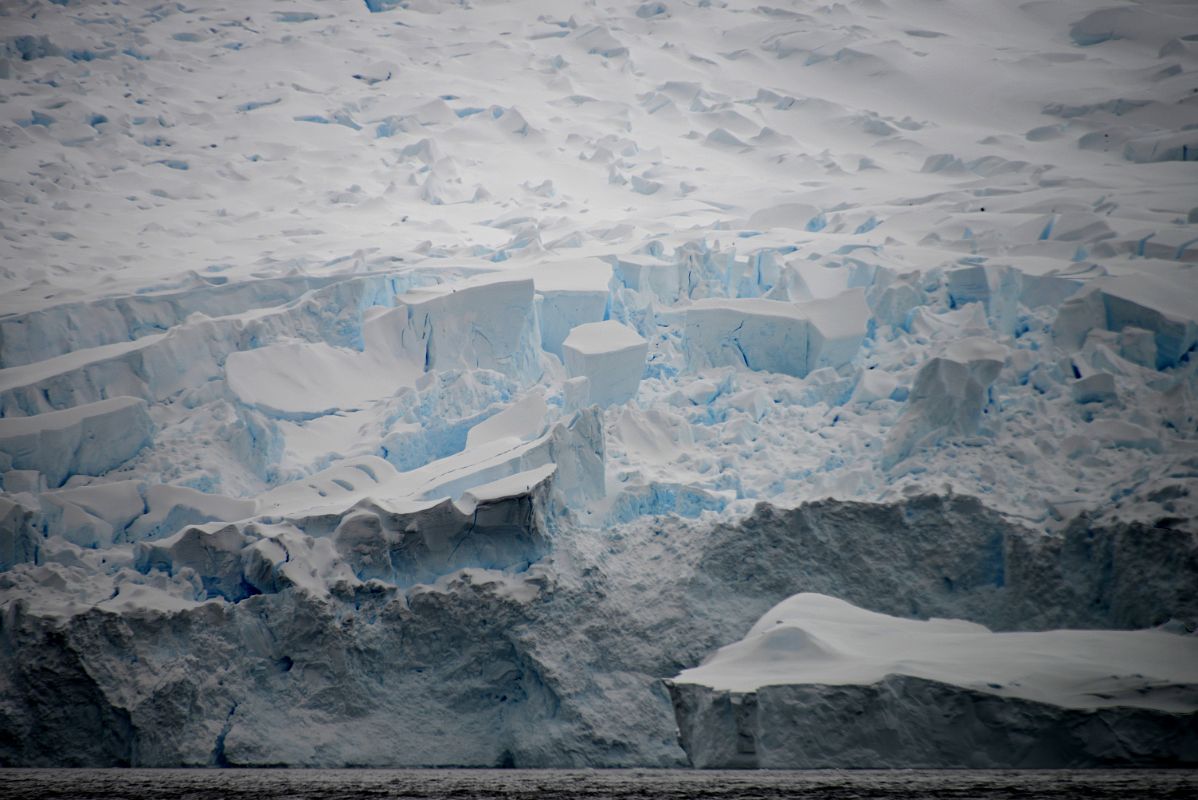 01C Massive Broken Ice Seracs Tumbling Down To The Water From Zodiac Near Danco Island On Quark Expeditions Antarctica Cruise